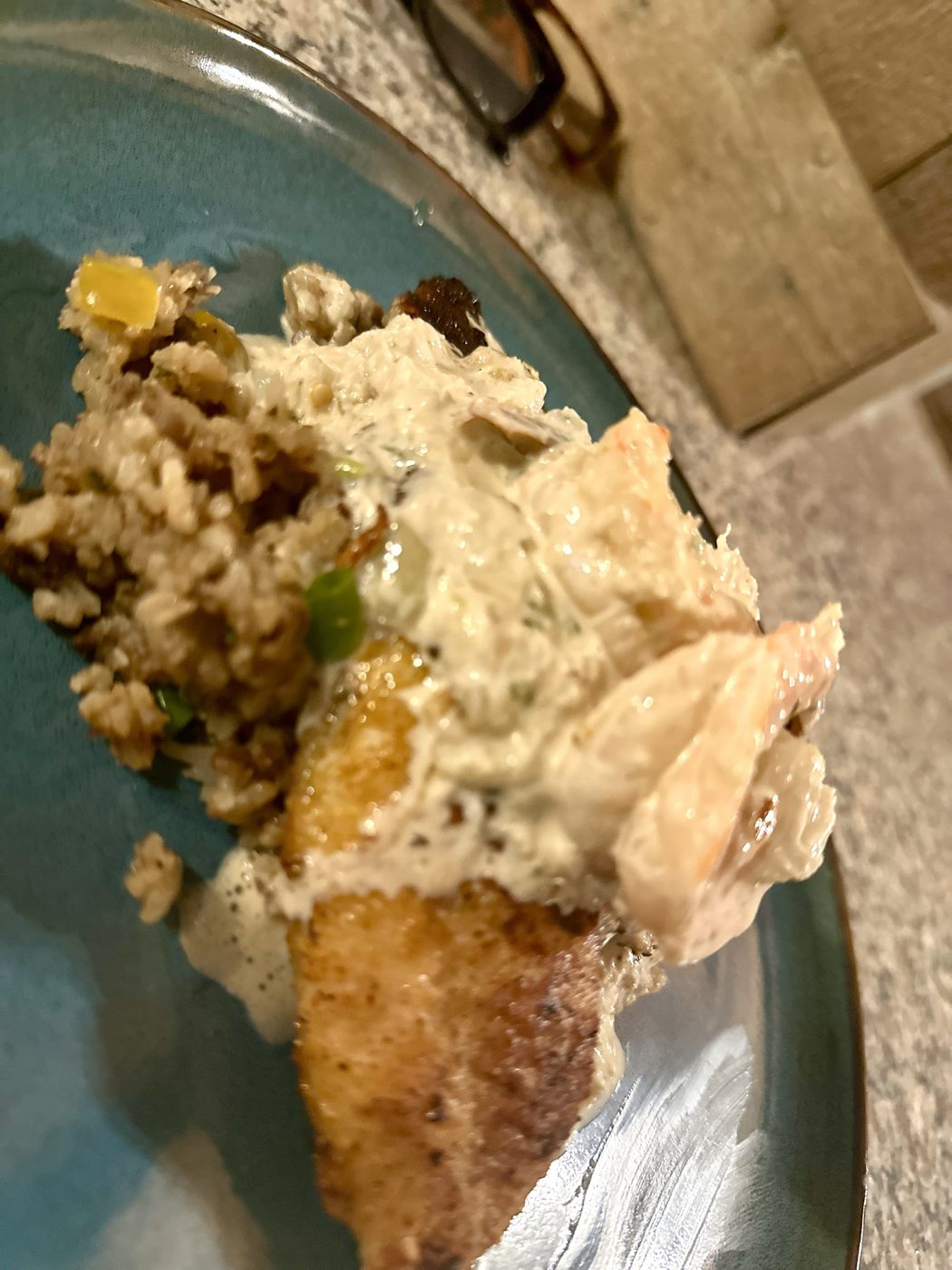 Blackened catfish, cream sauce and dirty rice